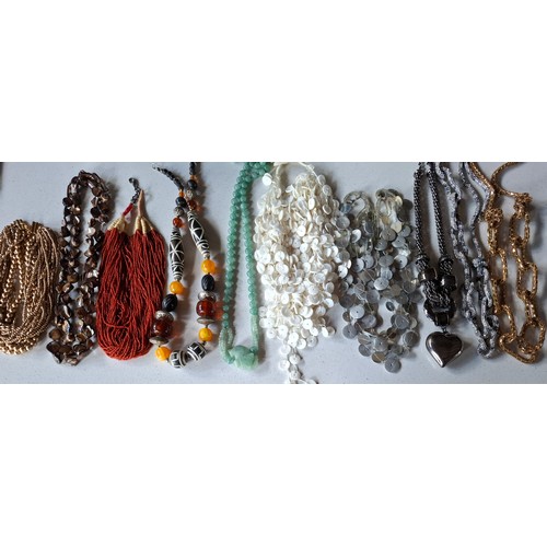 37 - Vintage necklaces to include an ethnic amber coloured bead necklace, a coral multi strand necklace a... 