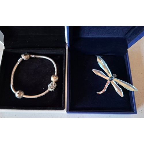 27 - Swarovski and Pandora- A Swarovski silver tone dragonfly brooch 719486 having inset crystals and a P... 