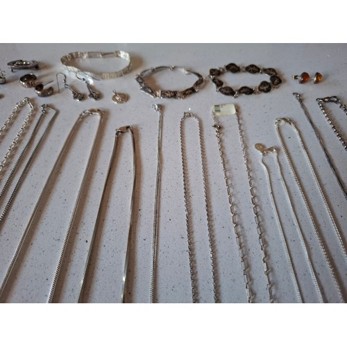 45 - A quantity of silver and white metal jewellery to include silver chains stamped 925, mixed pendants ... 