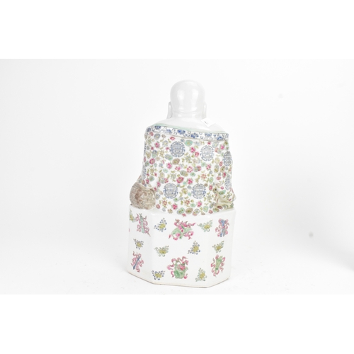 14 - A Chinese famille rose porcelain model of a Buddha, seated holding a beaded necklace, his robe decor... 