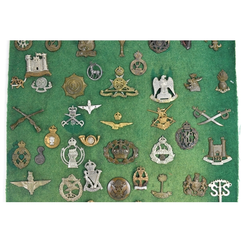A collection of mainly British military cap badges, including examples ...