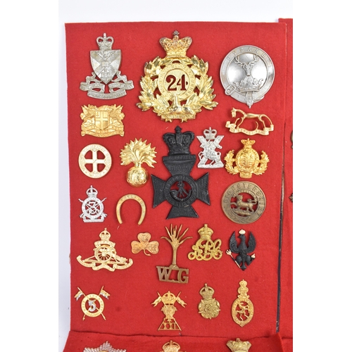 A collection of military cap badges, comprising six display boards ...