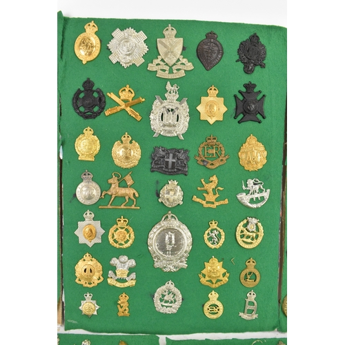 A collection of military cap badges and insignia, comprising five ...