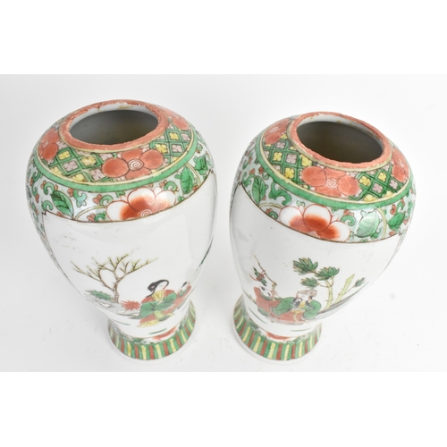 20 - A pair of 19th century Chinese famille vert vases in Kangxi style, of baluster form with elaborate p... 