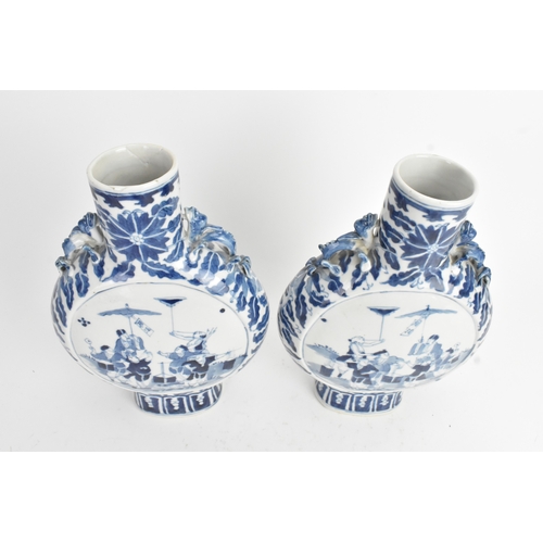 21 - A pair of Chinese blue and white porcelain moon flasks, late Qing dynasty, of flattened circular for... 