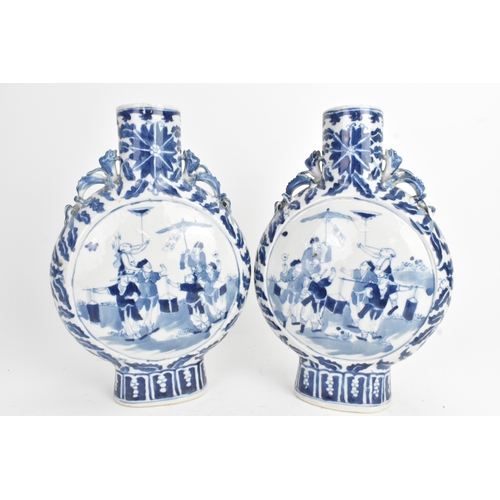 21 - A pair of Chinese blue and white porcelain moon flasks, late Qing dynasty, of flattened circular for... 