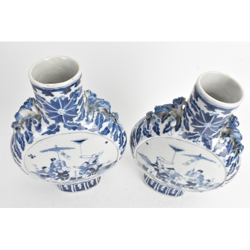 21 - A pair of Chinese blue and white porcelain moon flasks, late Qing dynasty, of flattened circular for... 