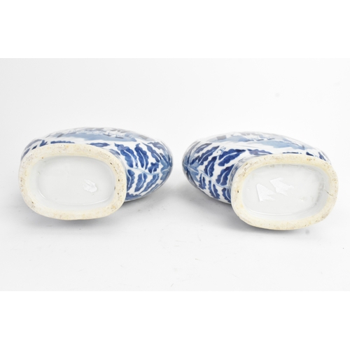 21 - A pair of Chinese blue and white porcelain moon flasks, late Qing dynasty, of flattened circular for... 
