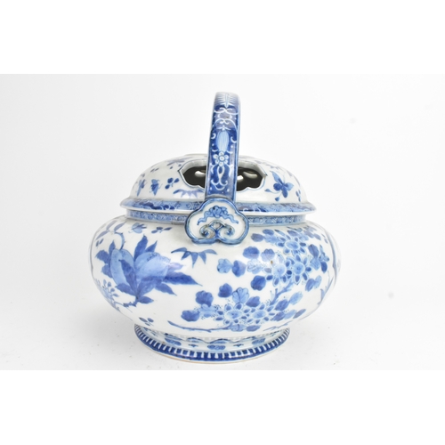 23 - A Japanese blue and white porcelain covered basket-form vessel, of globular form with domed pierced ... 