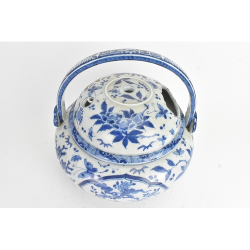 23 - A Japanese blue and white porcelain covered basket-form vessel, of globular form with domed pierced ... 