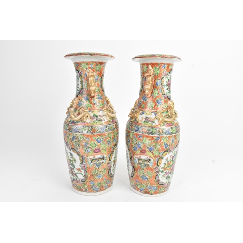 24 - A pair of Chinese export famille rose porcelain vases, late Qing dynasty, each with applied lion dog... 