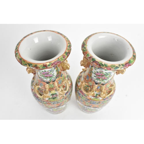 24 - A pair of Chinese export famille rose porcelain vases, late Qing dynasty, each with applied lion dog... 