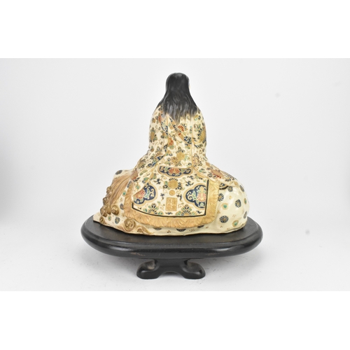 32 - A Japanese Satsuma figure group, early 20th century, modelled as Guanyin seated on a shi-shi lion, d... 