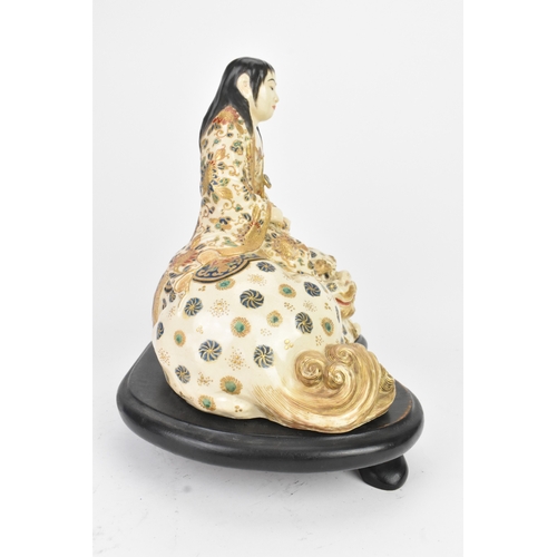 32 - A Japanese Satsuma figure group, early 20th century, modelled as Guanyin seated on a shi-shi lion, d... 