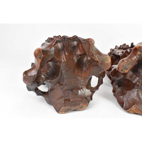 36 - A pair of Chinese hardwood carved figures of immortals, 20th century, each modelled standing holding... 