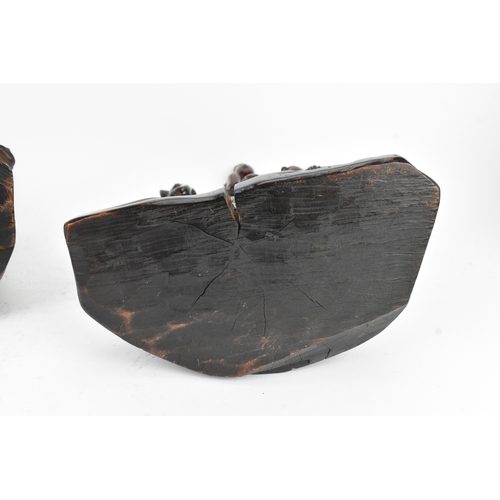 37 - Two Chinese hardwood carved figures, 20th century, one modelled seated upon a shi-shi lion and holdi... 