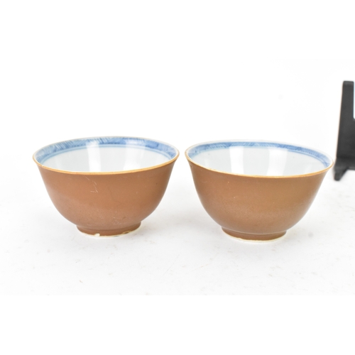 54 - Two Chinese Export Nanking Cargo cafe-au-lait blue and white tea bowls and saucers, Qianlong, mid 18... 