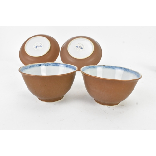 57 - Two Chinese Export Nanking Cargo cafe-au-lait blue and white tea bowls and saucers, Qianlong, mid 18... 