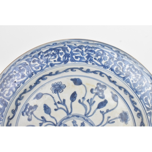 9 - A Chinese Qing dynasty blue and white porcelain charger, 18th century, the centre decorated with a r... 