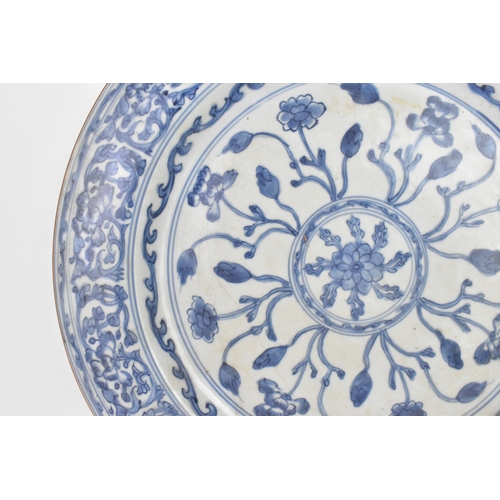 9 - A Chinese Qing dynasty blue and white porcelain charger, 18th century, the centre decorated with a r... 