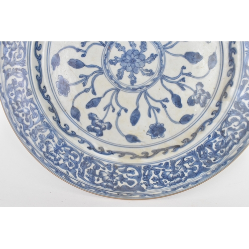 9 - A Chinese Qing dynasty blue and white porcelain charger, 18th century, the centre decorated with a r... 