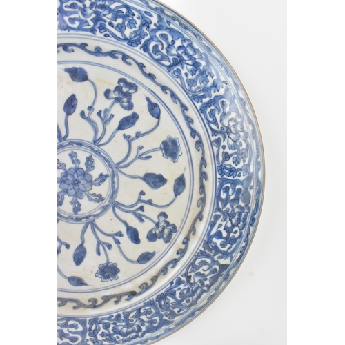 9 - A Chinese Qing dynasty blue and white porcelain charger, 18th century, the centre decorated with a r... 