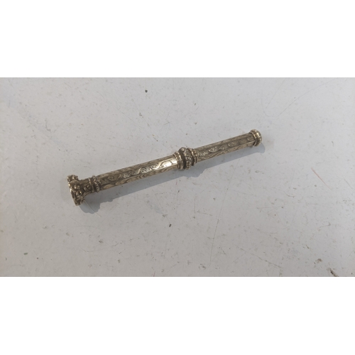 41 - A vintage propelling pencil with an engine turned design the case testing as 9ct gold weighing a tot... 