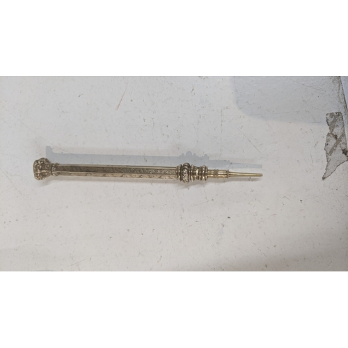41 - A vintage propelling pencil with an engine turned design the case testing as 9ct gold weighing a tot... 