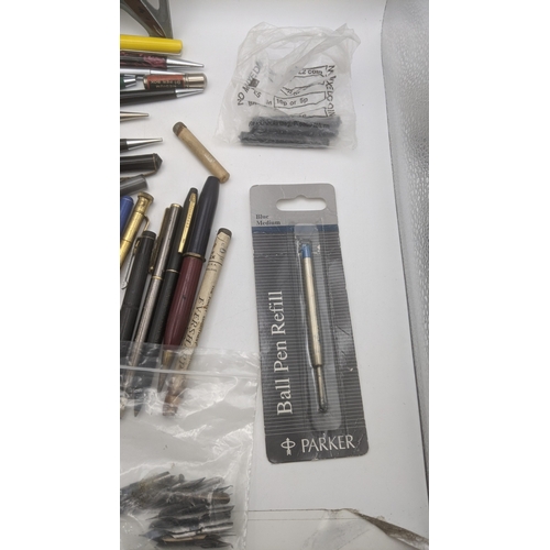 48 - A large collection of writing equipment to include four Superite gold plated propelling pencils, a P... 