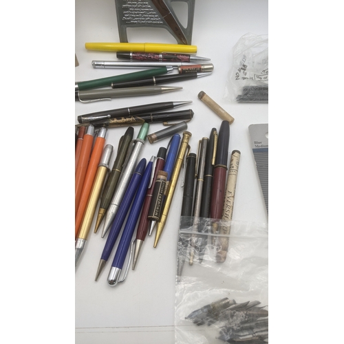 48 - A large collection of writing equipment to include four Superite gold plated propelling pencils, a P... 