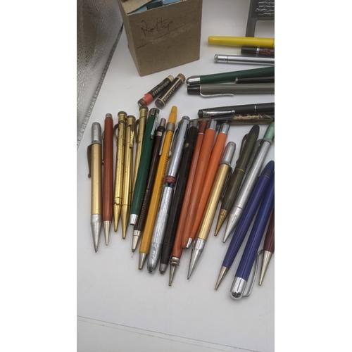 48 - A large collection of writing equipment to include four Superite gold plated propelling pencils, a P... 