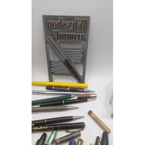 48 - A large collection of writing equipment to include four Superite gold plated propelling pencils, a P... 