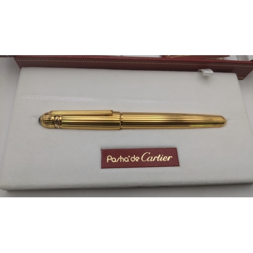 50 - An unused Pasha de Cartier gold plated ballpoint pen circa 1991 no 06303 with box, guarantee user gu... 