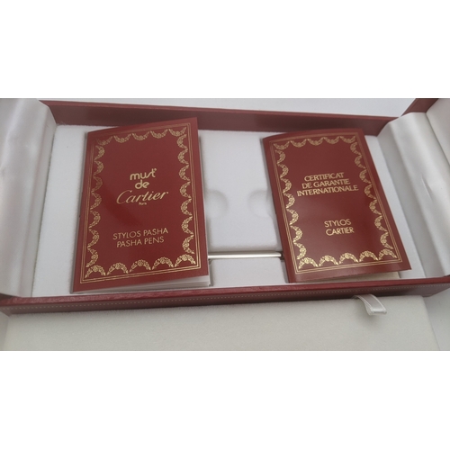 50 - An unused Pasha de Cartier gold plated ballpoint pen circa 1991 no 06303 with box, guarantee user gu... 