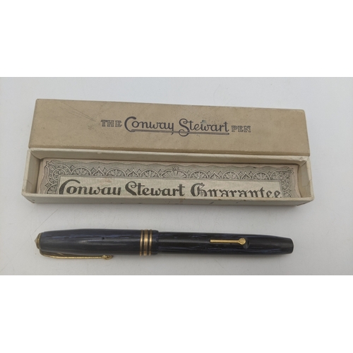 53 - Vintage writing equipment to include a boxed Conway Stewart 36 fountain pen with a blue striped desi... 