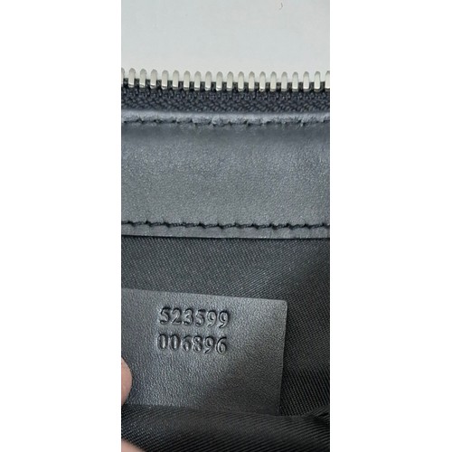 7 - Gucci- A circa 2020 GG supreme canvas messenger bag in grey having silver tone hardware and a navy a... 