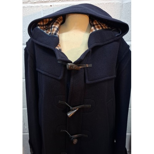 22 - Aquascutum- A gents navy wool mix duffle coat having 3 horn toggle buttons, a hood, tartan fleece li... 