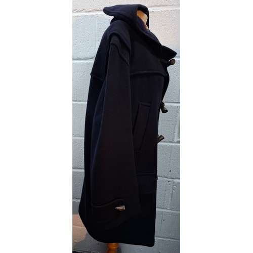 22 - Aquascutum- A gents navy wool mix duffle coat having 3 horn toggle buttons, a hood, tartan fleece li... 