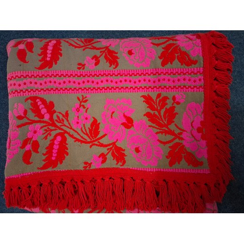 42 - A late 1960's double-sided pink, red and grey/green machine made bed throw having a floral design an... 