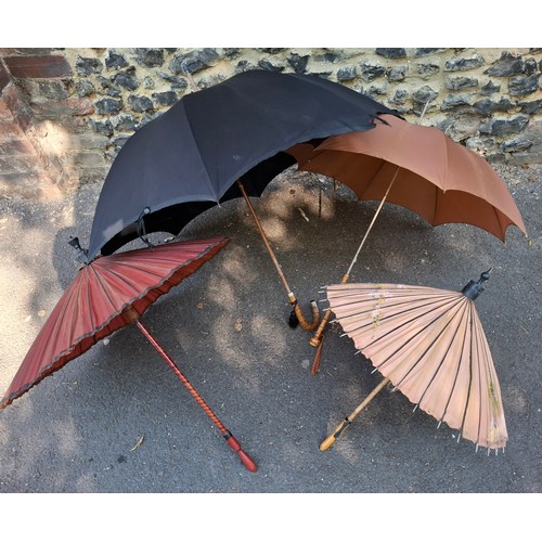 43 - Four vintage umbrellas and parasols to include a British made black umbrella having a silver end, ma... 