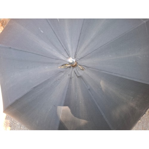 43 - Four vintage umbrellas and parasols to include a British made black umbrella having a silver end, ma... 