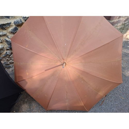 43 - Four vintage umbrellas and parasols to include a British made black umbrella having a silver end, ma... 
