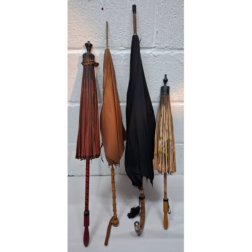 43 - Four vintage umbrellas and parasols to include a British made black umbrella having a silver end, ma... 