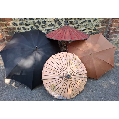 43 - Four vintage umbrellas and parasols to include a British made black umbrella having a silver end, ma... 