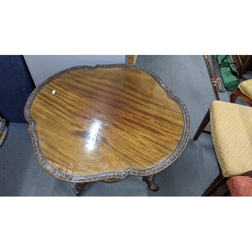 470 - A Georgian inspired early 20th century mahogany occasional table having a shaped top, turned columns... 