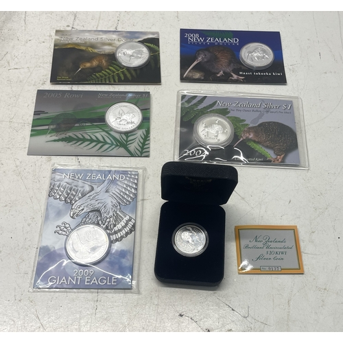 20 - A collection of five New Zealand $1 silver coins in presentation packs and a 1998 New Zealand $10 wi... 