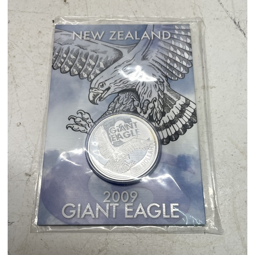 20 - A collection of five New Zealand $1 silver coins in presentation packs and a 1998 New Zealand $10 wi... 