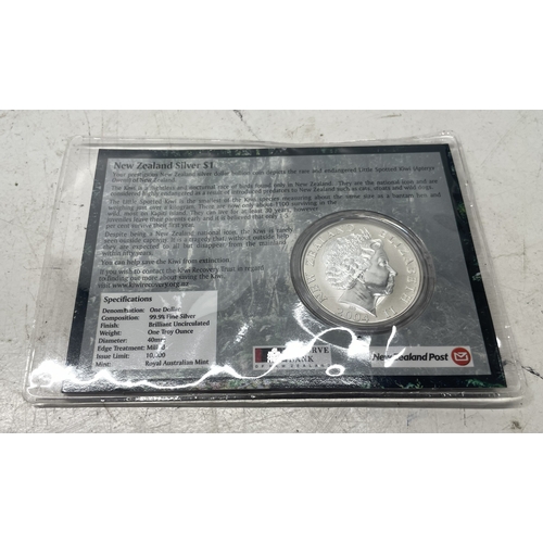 20 - A collection of five New Zealand $1 silver coins in presentation packs and a 1998 New Zealand $10 wi... 