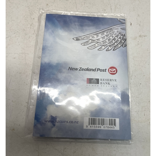 20 - A collection of five New Zealand $1 silver coins in presentation packs and a 1998 New Zealand $10 wi... 
