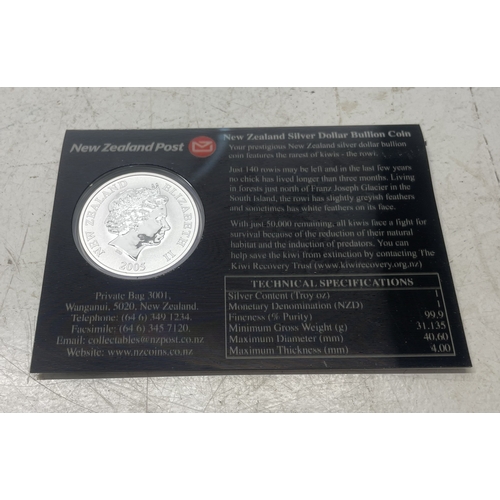 20 - A collection of five New Zealand $1 silver coins in presentation packs and a 1998 New Zealand $10 wi... 